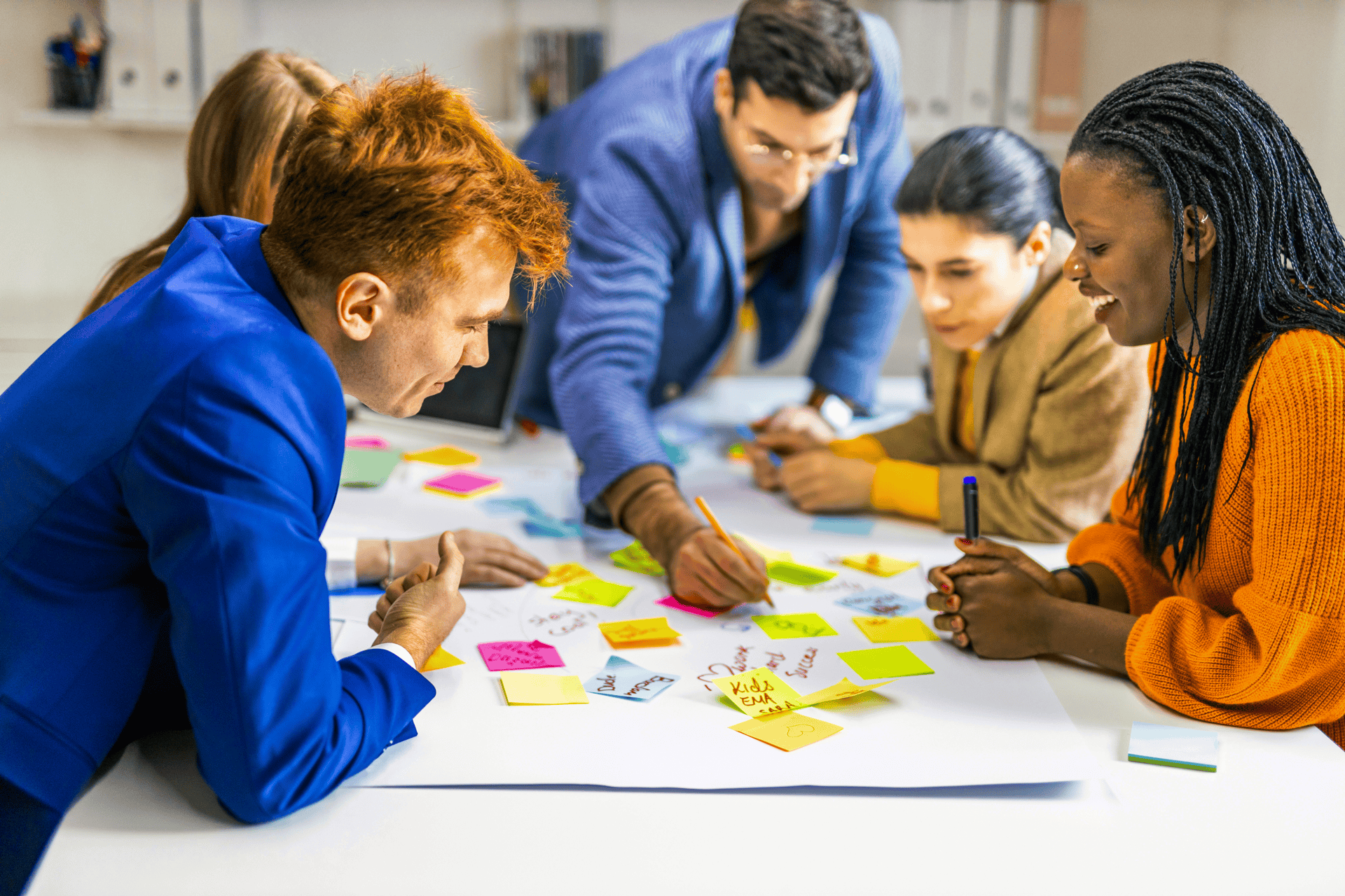 group of associates brainstorming at table