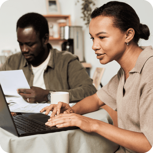 Woman focusing on her laptop during a business meeting